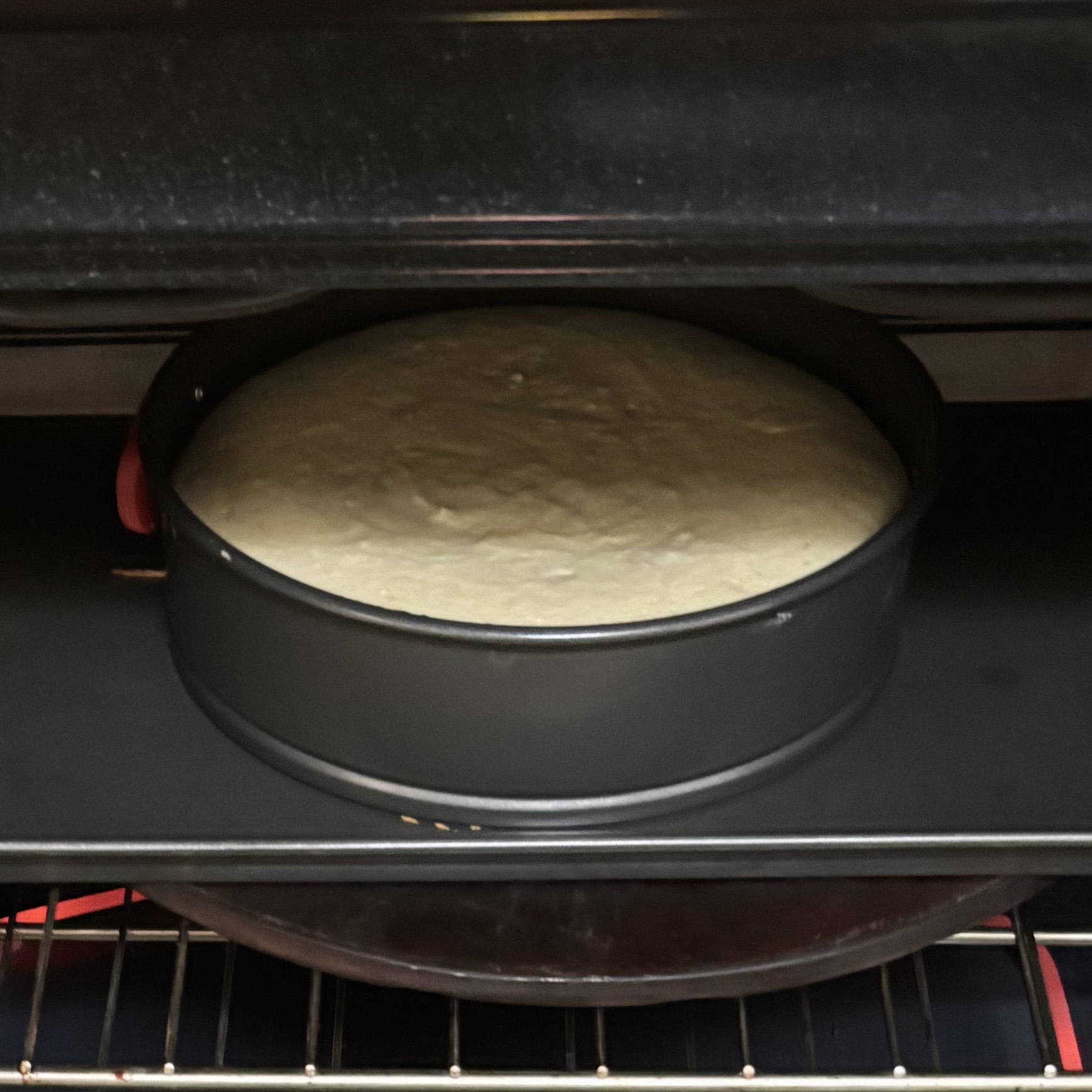Cake pan full of batter in the oven
